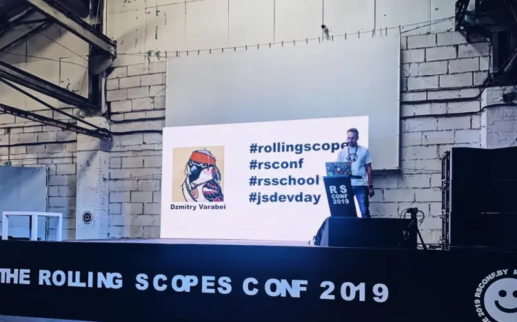 Dzmitry Varabei delivers a talk at RS Conf 2019 with hashtags and graphics displayed on screen